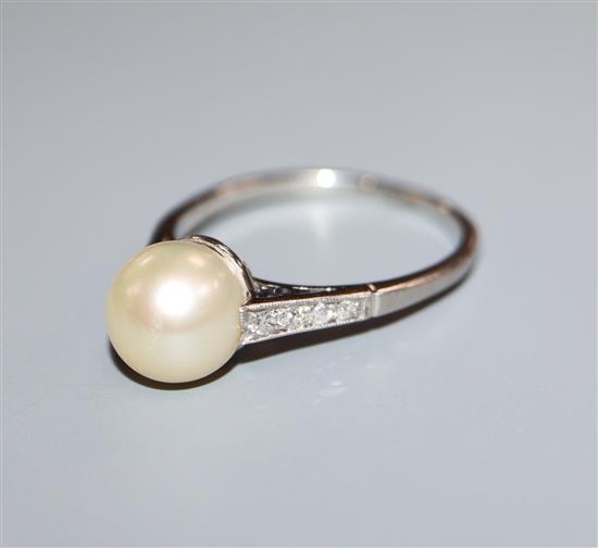 A white metal (stamped Plat) and cultured pearl dress ring with diamond set shoulders, size O/P.